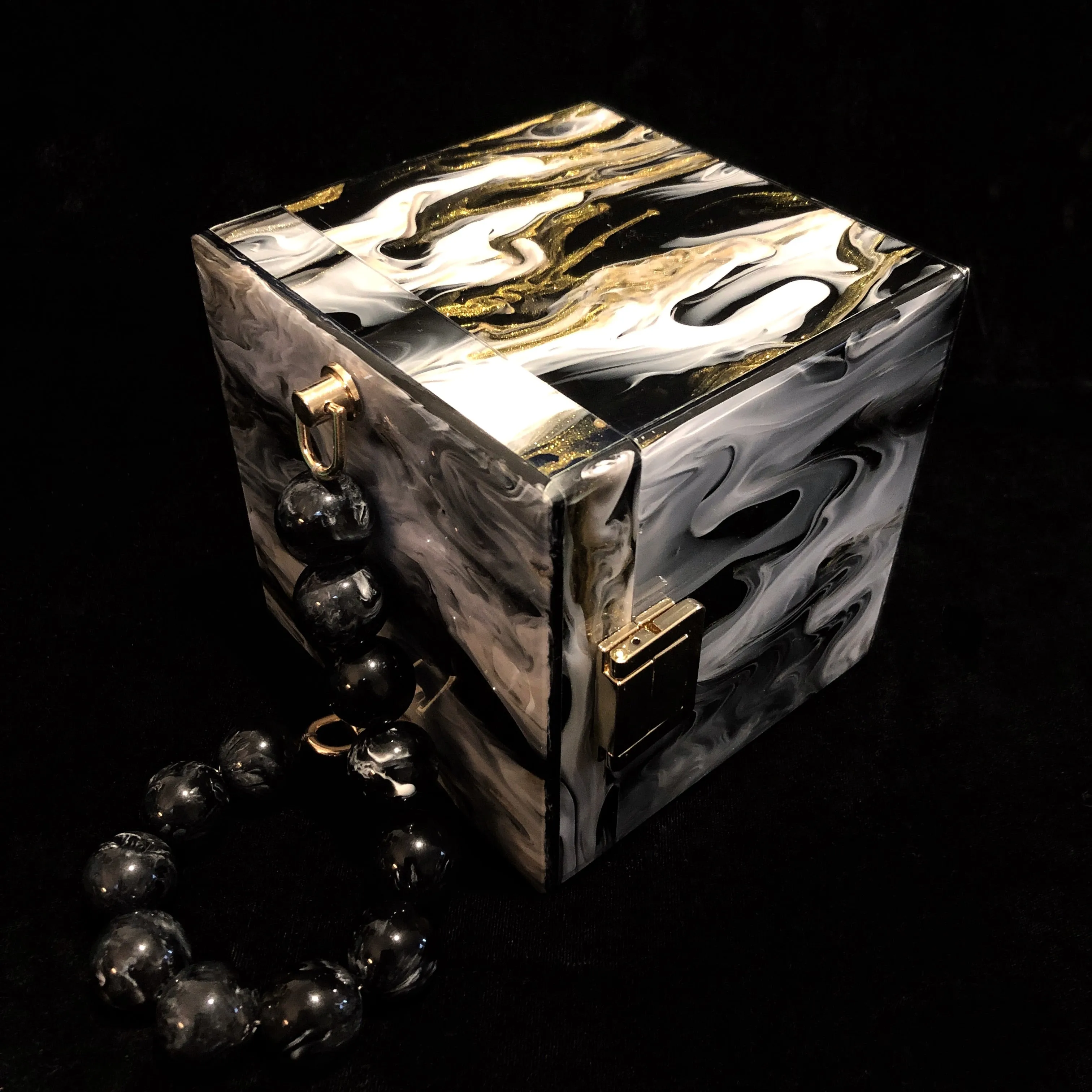 A MARBLED PERSPEX CUBE BAG