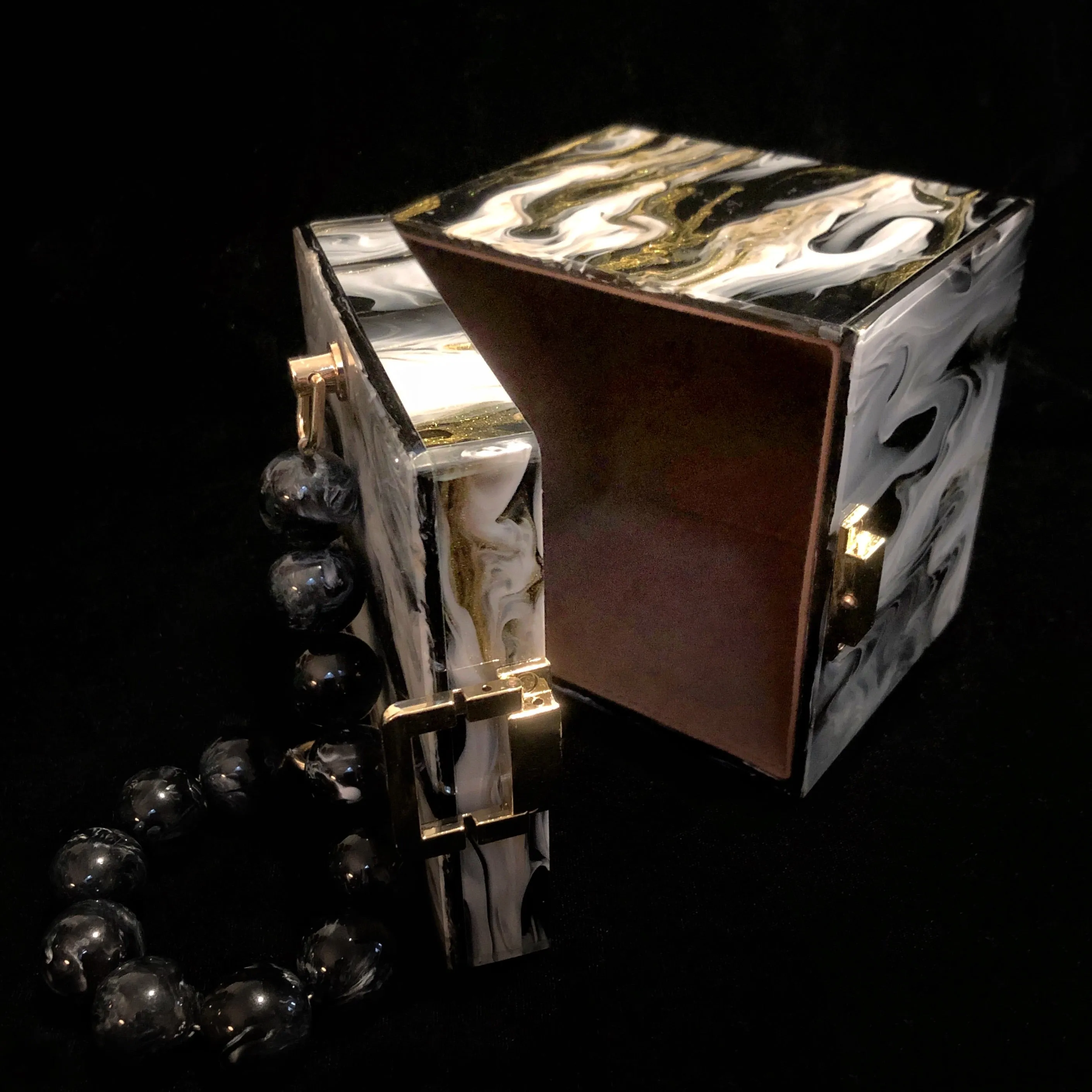 A MARBLED PERSPEX CUBE BAG